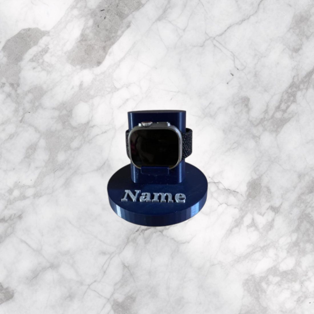 A blue Apple Watch charging stand with a name on the base